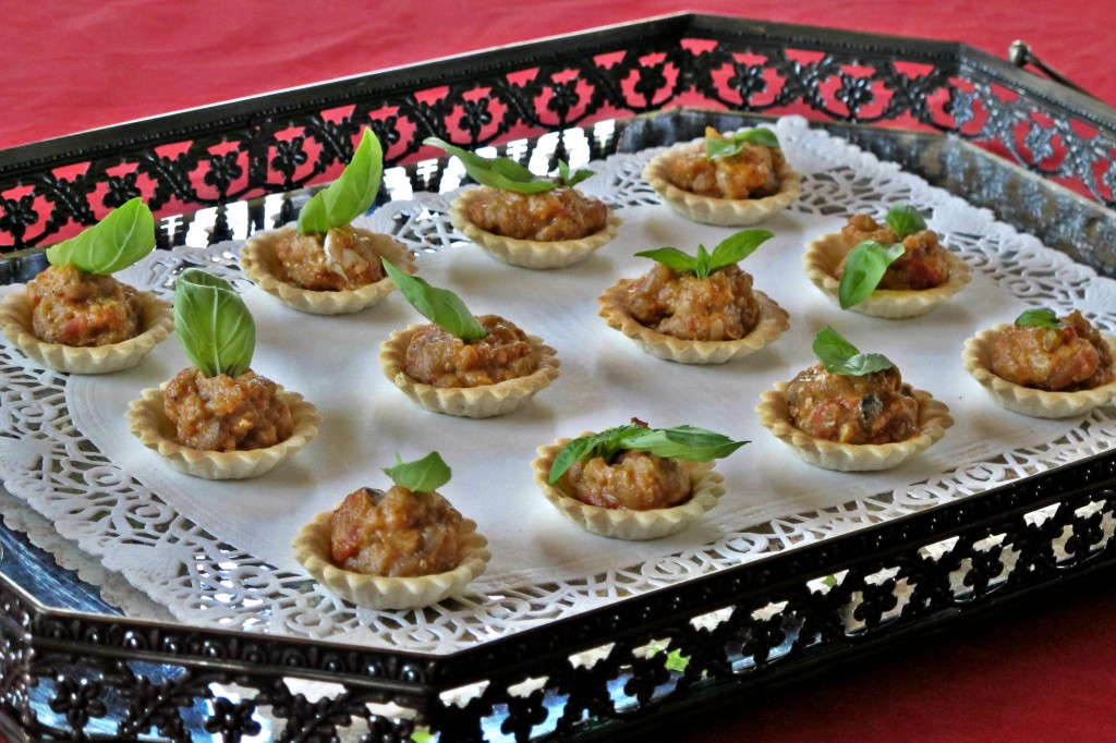 Mirzaghasemi Tartlets Tiny tartlets garnished with mixed aubergine, grilled tomato and egg.